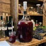 Glass fermentation carboy with airlock for homemade wine